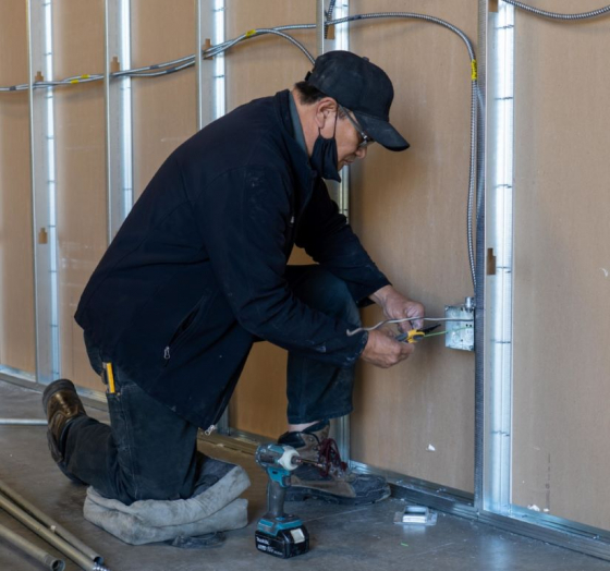 A Philco employee installing outlets in a commercial clients new build