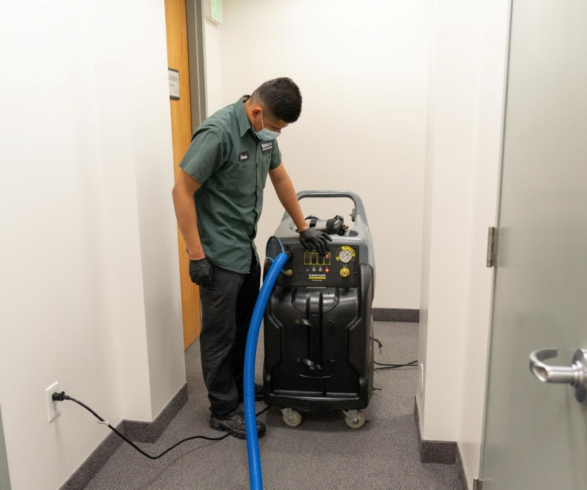 A Philco employee performing a carpet extraction at a commercial clients office