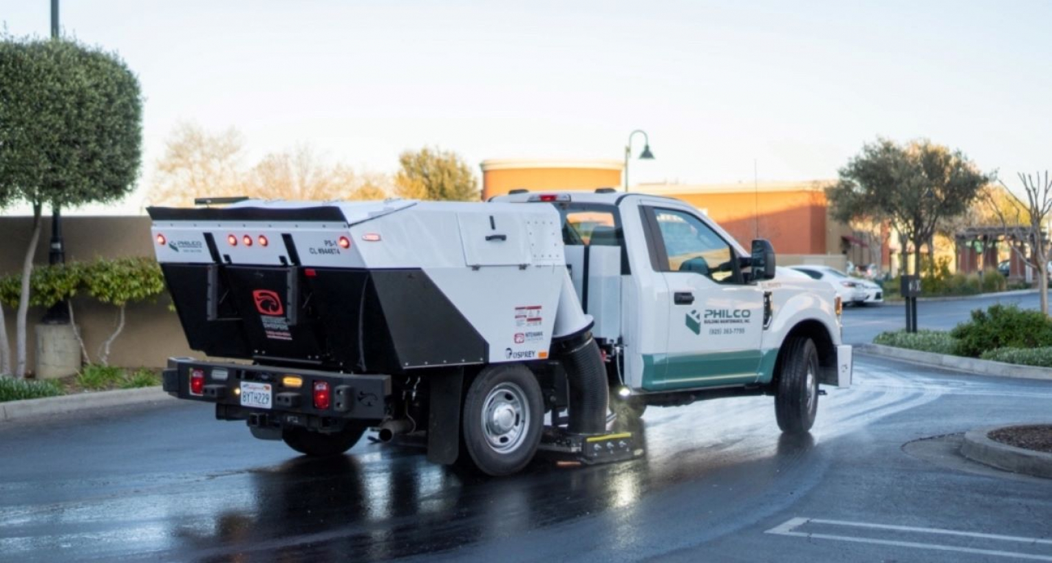 A Philco truck cleaning a clients parking lot surface