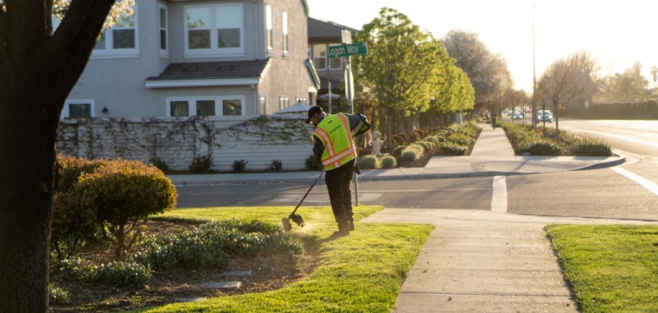 A Philco employee trimming the edges of a clients lawn